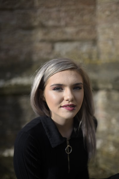 A woman in a black shirt with a smile
